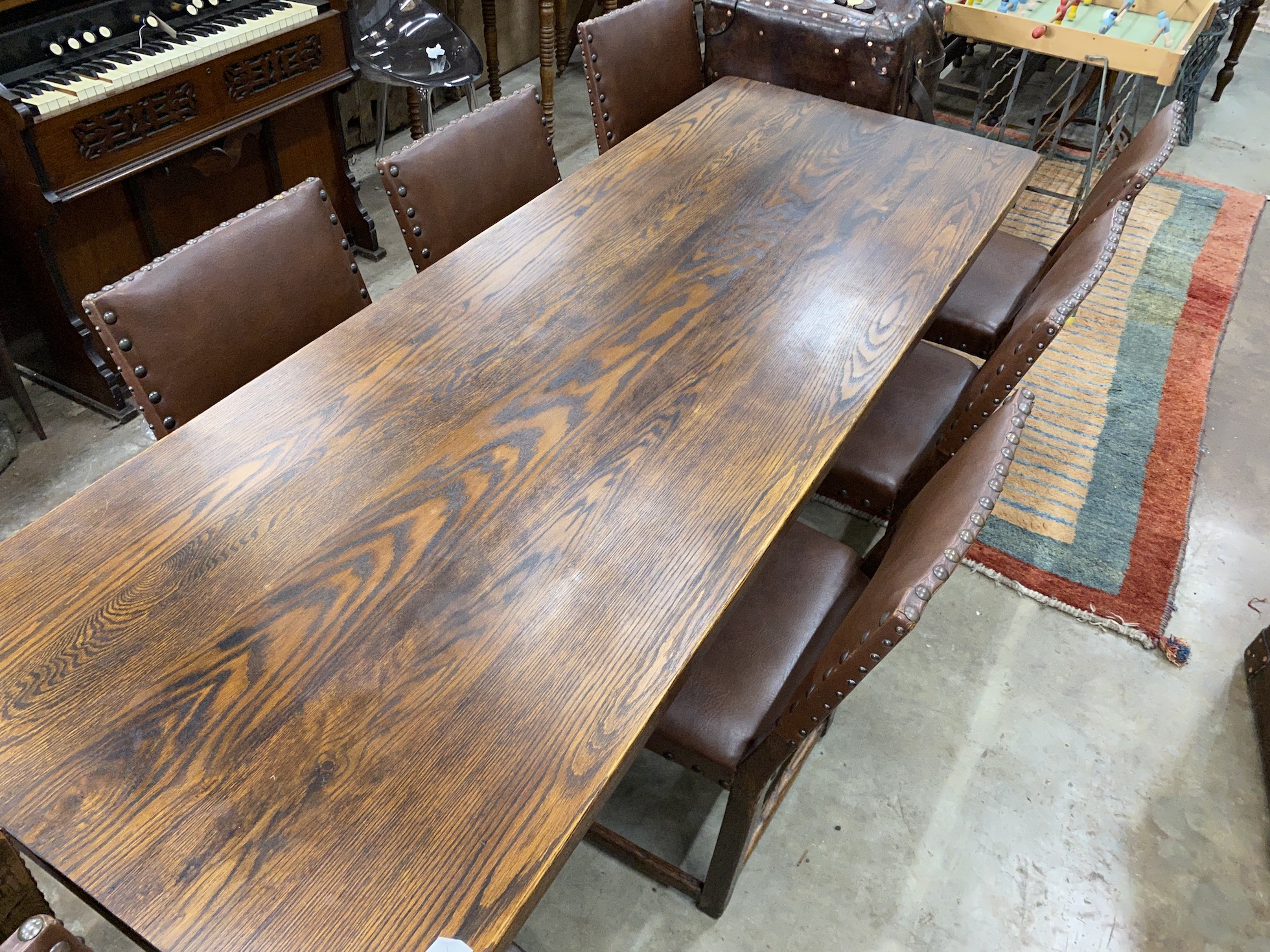 An 18th century style rectangular oak refectory dining table, length 214cm, depth 78cm, height 75cm together with a set of eight oak dining chairs